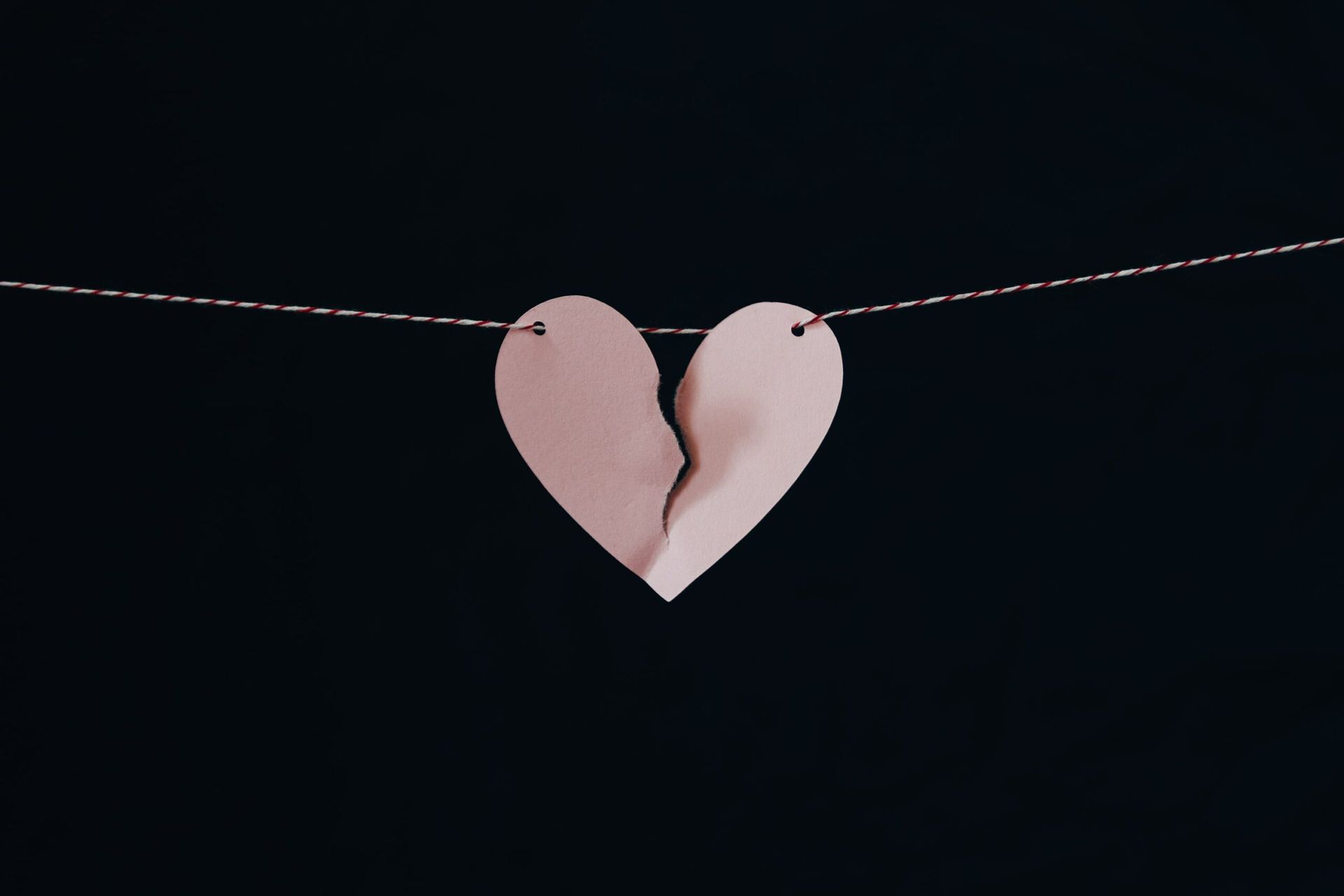 Image of a broken paper heart.